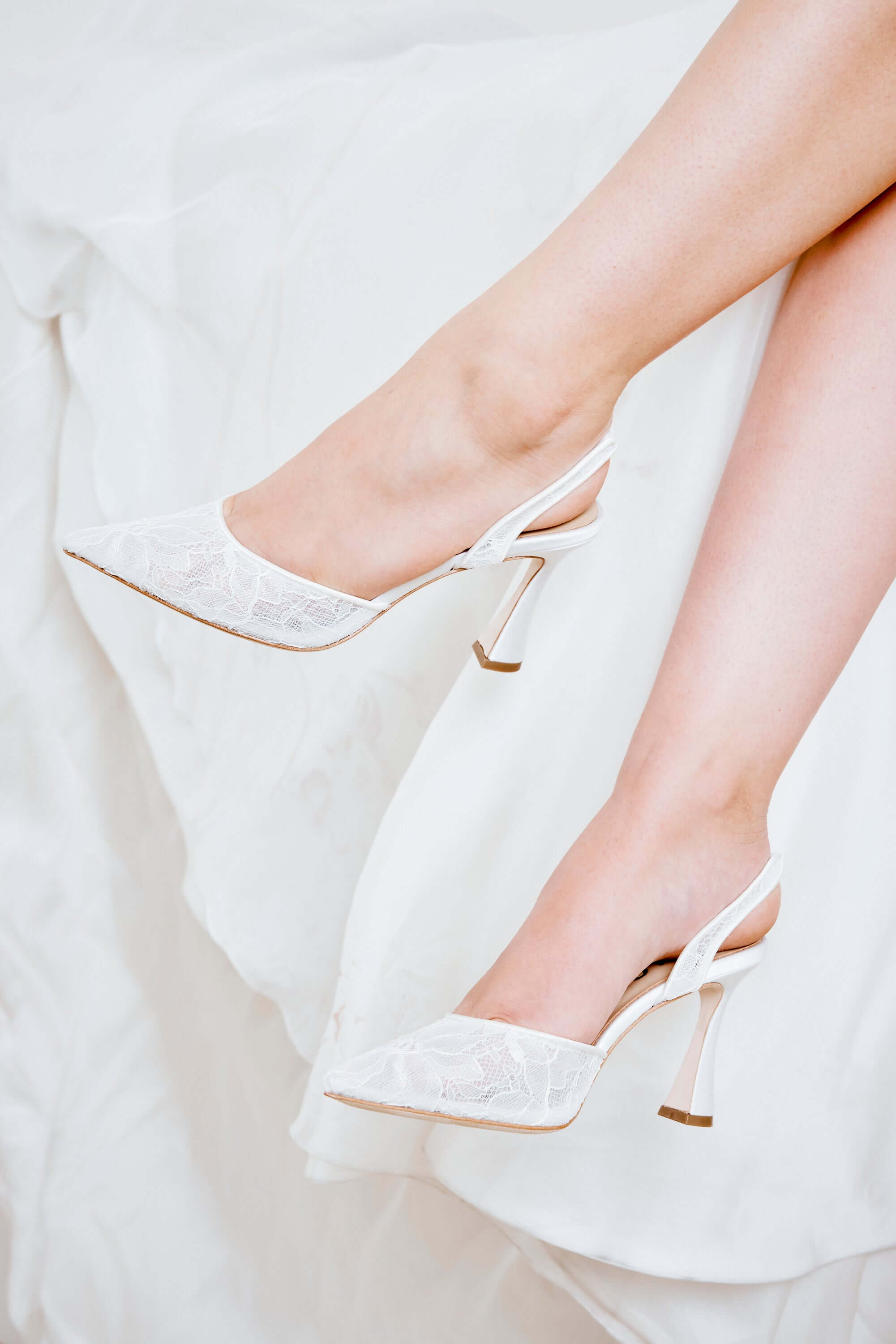 Gigi Lace - Bridal Slingback Fluted Heels - Soft White elegantly showcased on a model's feet, featuring delicate floral lace.