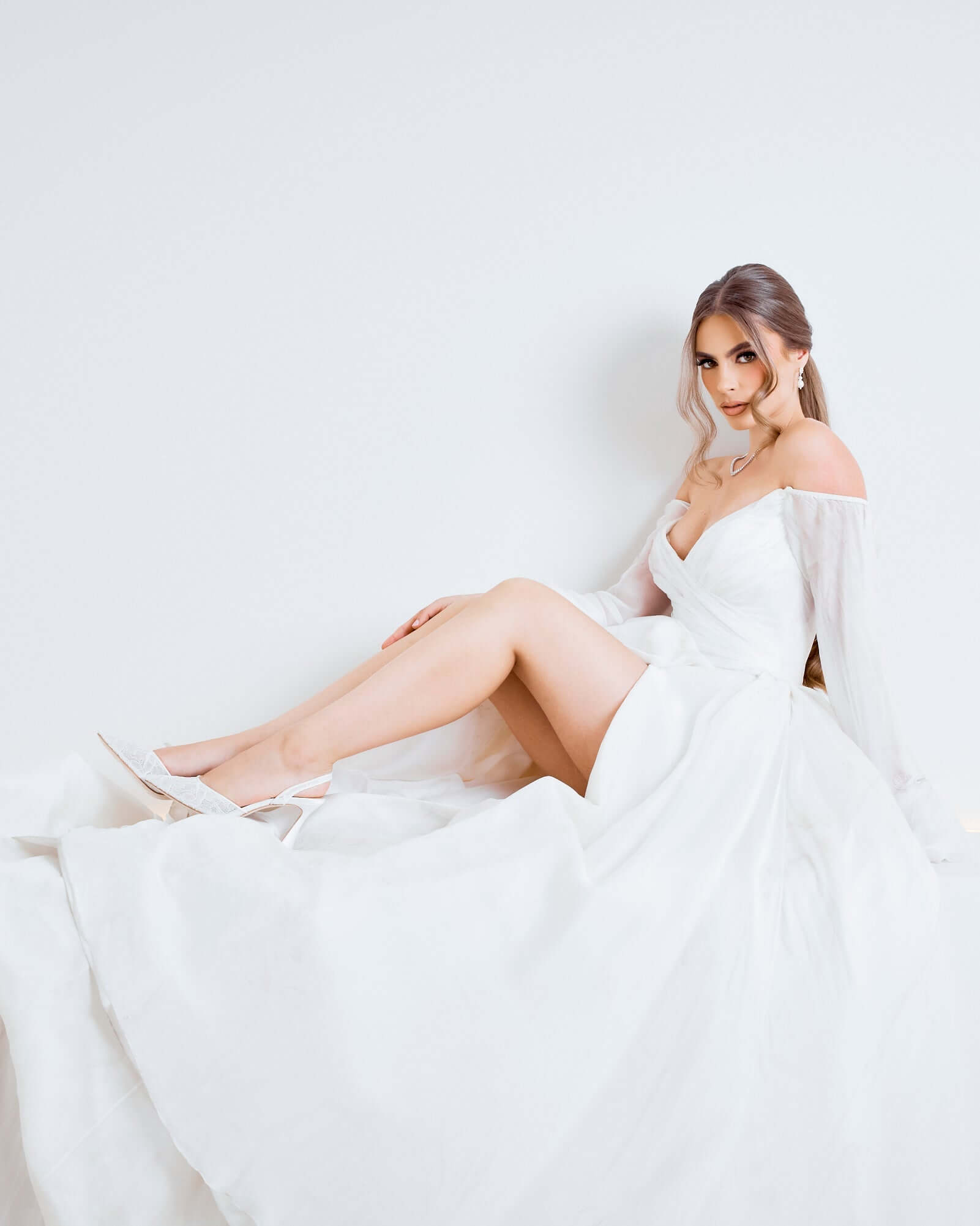 Gigi Lace - Bridal Slingback Fluted Heels - Soft White worn with a flowing white bridal dress, showcasing elegance and style.